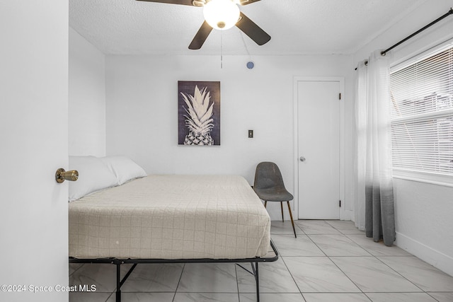 3524 S Atlantic Ave, Cocoa Beach, FL 32931 - bedroom featuring ceiling fan and a textured ceiling