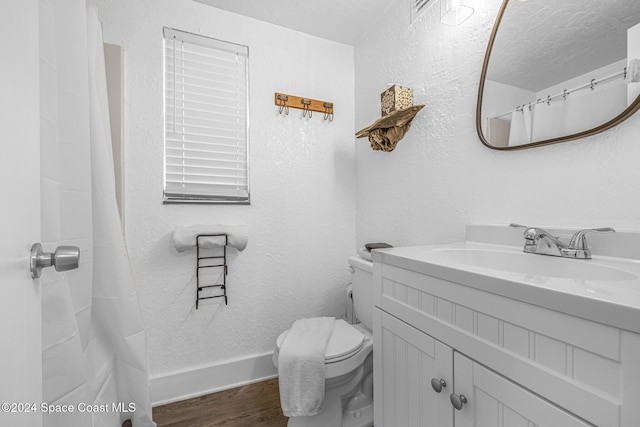 3524 S Atlantic Ave, Cocoa Beach, FL 32931 - bathroom with wood finished floors, toilet, vanity, and baseboards