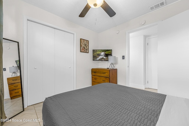 3524 S Atlantic Ave, Cocoa Beach, FL 32931 - bedroom with a closet, ceiling fan, and a textured ceiling