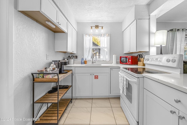3524 S Atlantic Ave, Cocoa Beach, FL 32931 - kitchen featuring white electric range oven, light countertops, light marble finish floors, a textured wall, and a textured ceiling