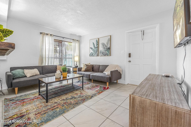 3524 S Atlantic Ave, Cocoa Beach, FL 32931 - living room with light marble finish floors and a textured ceiling