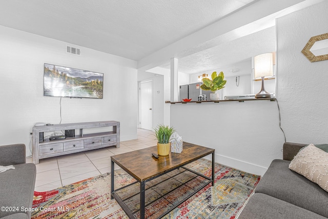 3524 S Atlantic Ave, Cocoa Beach, FL 32931 - living area with light tile patterned floors and a textured ceiling