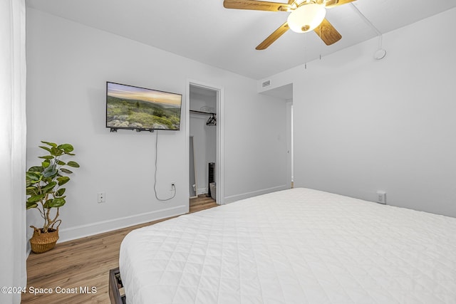 3524 S Atlantic Ave, Cocoa Beach, FL 32931 - bedroom with wood finished floors, baseboards, ceiling fan, and a walk in closet
