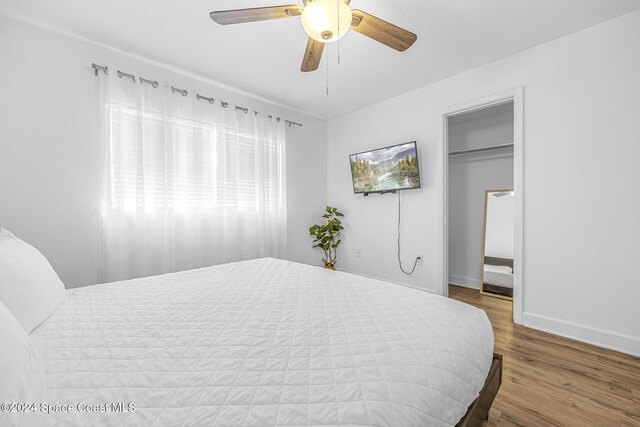 3524 S Atlantic Ave, Cocoa Beach, FL 32931 - bedroom featuring baseboards, wood finished floors, ceiling fan, and a spacious closet