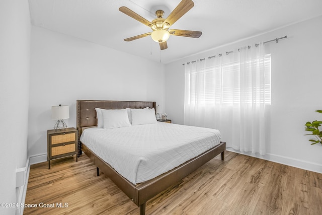 3524 S Atlantic Ave, Cocoa Beach, FL 32931 - bedroom featuring light wood-type flooring, baseboards, and ceiling fan