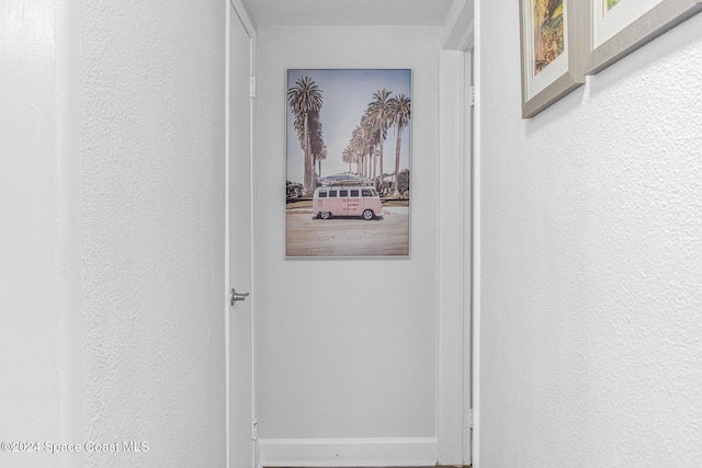3524 S Atlantic Ave, Cocoa Beach, FL 32931 - hall with baseboards and a textured wall