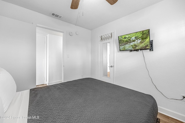 3524 S Atlantic Ave, Cocoa Beach, FL 32931 - unfurnished bedroom featuring wood finished floors, ceiling fan, and baseboards