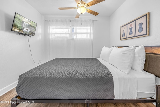 3524 S Atlantic Ave, Cocoa Beach, FL 32931 - bedroom featuring wood finished floors, ceiling fan, and baseboards