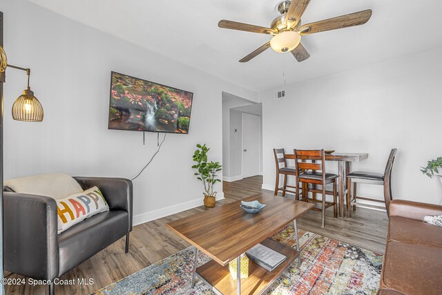 3524 S Atlantic Ave, Cocoa Beach, FL 32931 - living area featuring ceiling fan, wood finished floors, and baseboards
