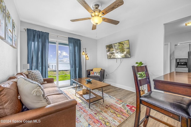 3524 S Atlantic Ave, Cocoa Beach, FL 32931 - living room featuring wood finished floors, ceiling fan, and baseboards