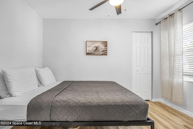 3524 S Atlantic Ave, Cocoa Beach, FL 32931 - bedroom with light wood-style floors, baseboards, ceiling fan, and a closet