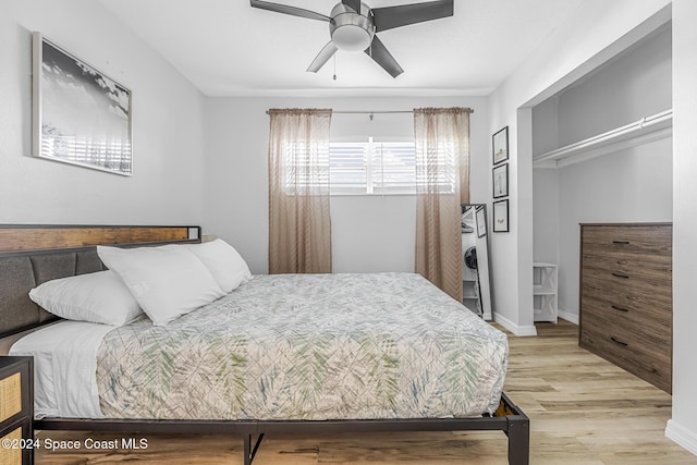 3524 S Atlantic Ave, Cocoa Beach, FL 32931 - bedroom with light wood finished floors, baseboards, and ceiling fan