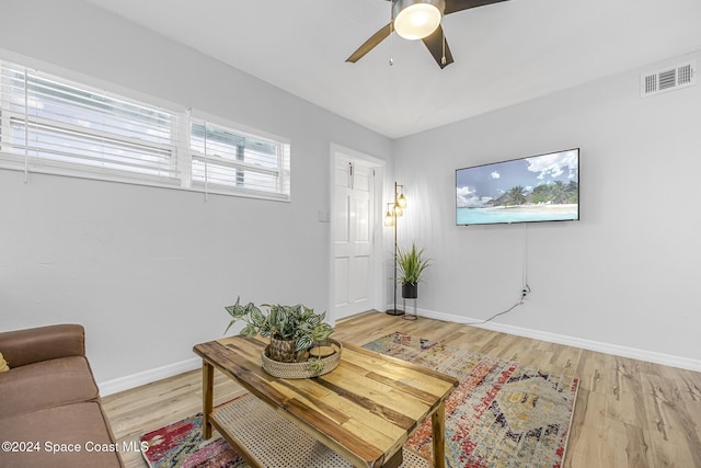 3524 S Atlantic Ave, Cocoa Beach, FL 32931 - living room featuring ceiling fan, light wood-style floors, and baseboards