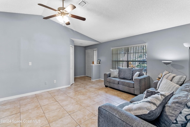 tiled living room featuring a textured ceiling, ceiling fan, and lofted ceiling