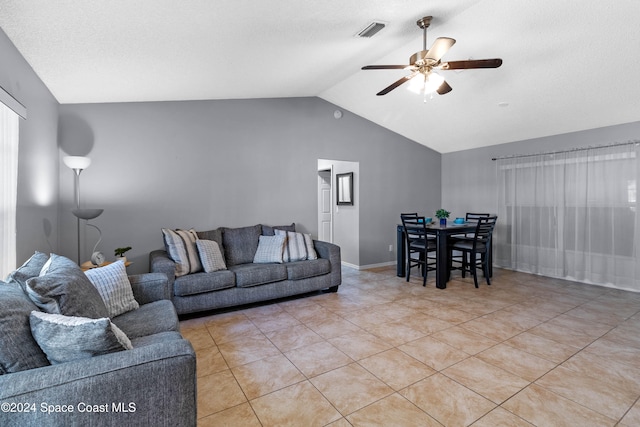 tiled living room with ceiling fan and lofted ceiling