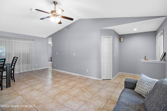 living room featuring ceiling fan, light tile patterned flooring, and lofted ceiling