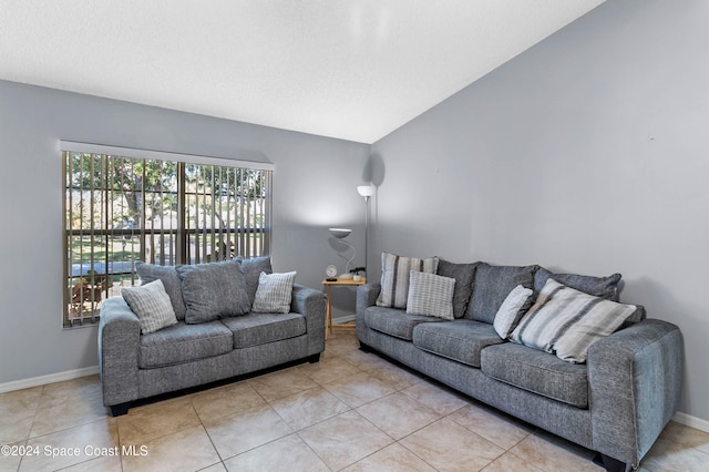 living room featuring light tile patterned floors and lofted ceiling