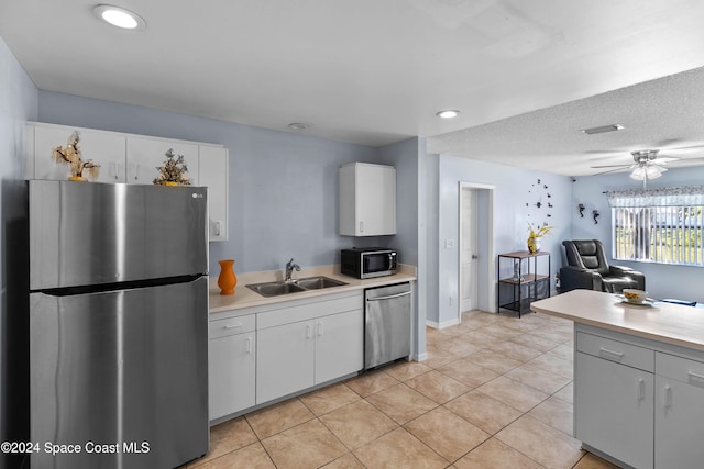 kitchen featuring white cabinets, appliances with stainless steel finishes, ceiling fan, and sink