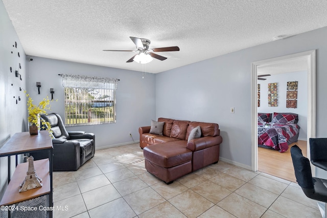 tiled living room with a textured ceiling and ceiling fan