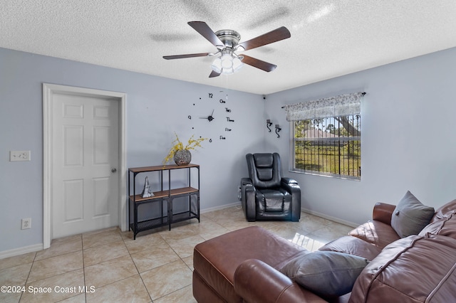 living room featuring light tile patterned floors, a textured ceiling, and ceiling fan