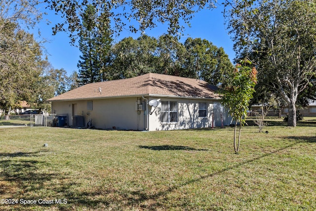 view of property exterior featuring a yard and central AC