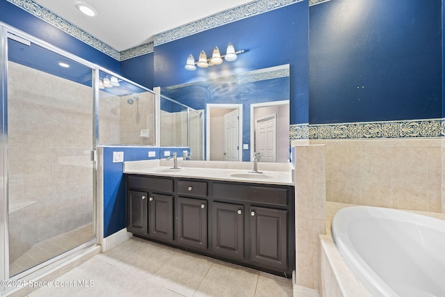 bathroom featuring vanity, tile patterned flooring, and plus walk in shower