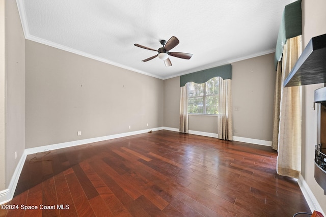 spare room with a textured ceiling, dark hardwood / wood-style floors, ceiling fan, and crown molding