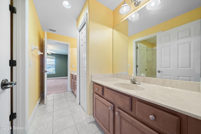 bathroom with tile patterned floors, vanity, and walk in shower