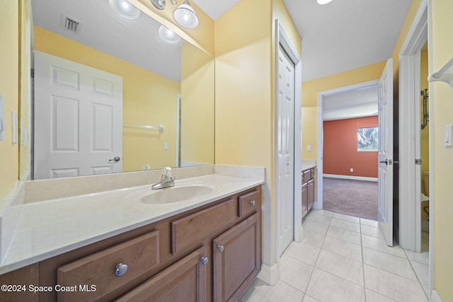 bathroom featuring tile patterned floors, vanity, and toilet