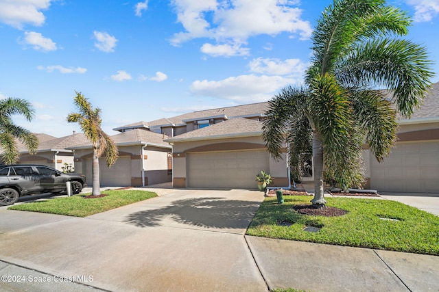 view of front of property featuring a garage and a front lawn