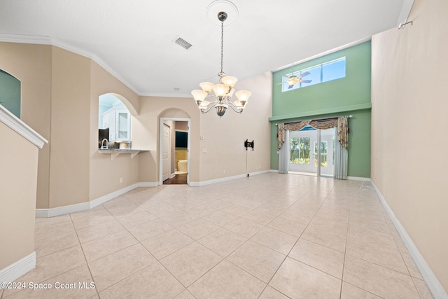 empty room with crown molding, light tile patterned floors, and ceiling fan with notable chandelier