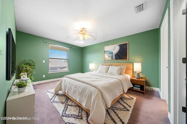 bedroom with dark colored carpet and ceiling fan