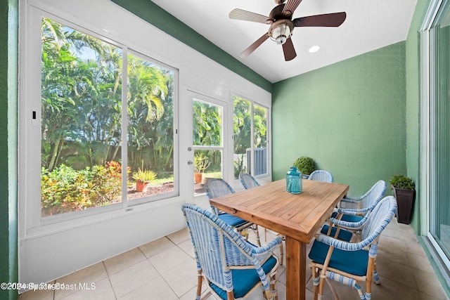 sunroom featuring ceiling fan