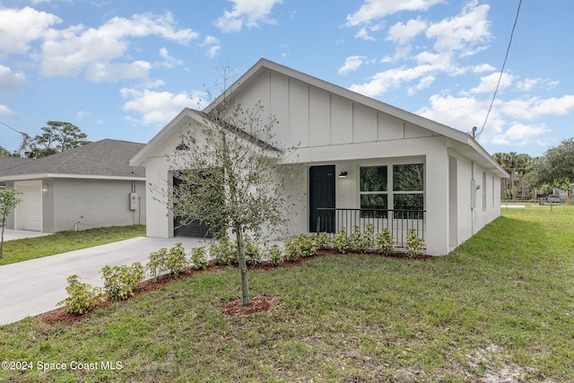 view of front of property featuring a garage and a front lawn