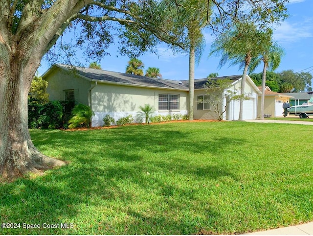 ranch-style home featuring a garage and a front yard