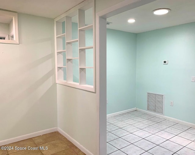 hall with light tile patterned floors