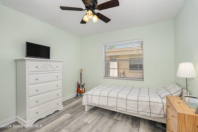 bedroom with light hardwood / wood-style floors and ceiling fan