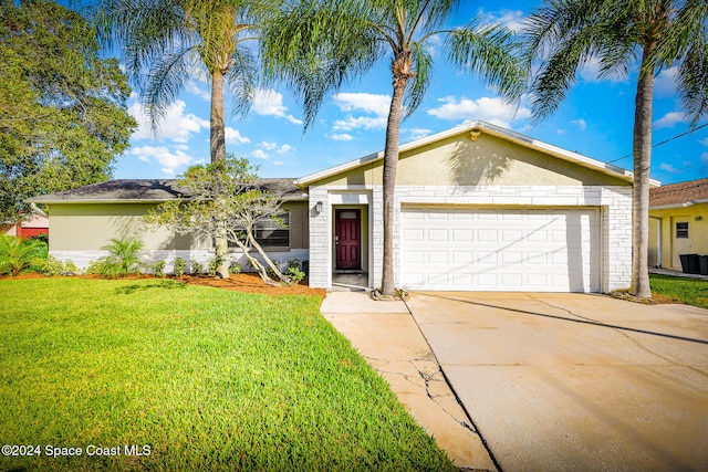 single story home featuring a front lawn and a garage