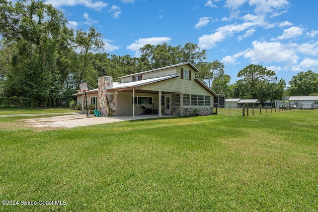 rear view of house with a lawn