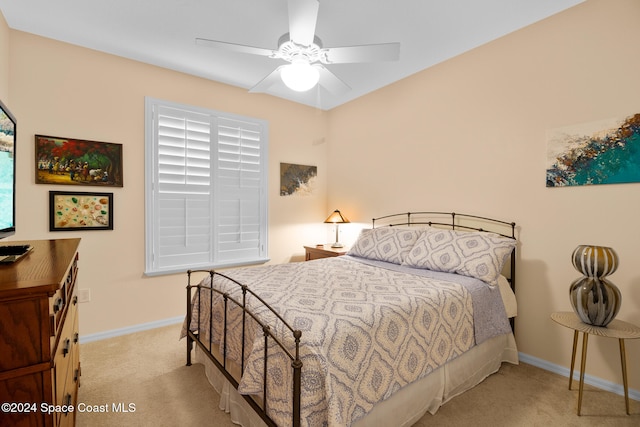 bedroom featuring light colored carpet and ceiling fan