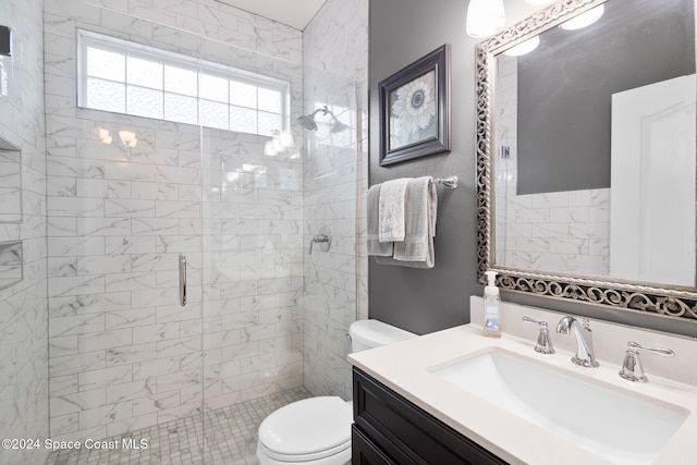 bathroom with vanity, toilet, and a shower with door