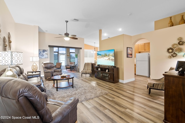 living room featuring light wood-type flooring, ceiling fan, and vaulted ceiling