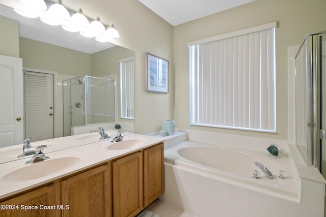 bathroom featuring tile patterned flooring, vanity, and shower with separate bathtub