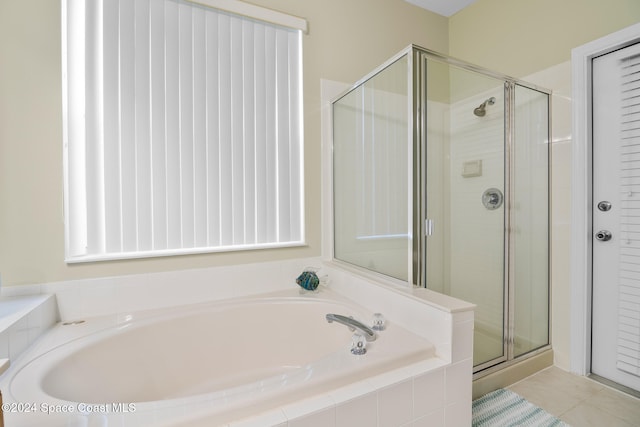 bathroom with tile patterned floors and separate shower and tub