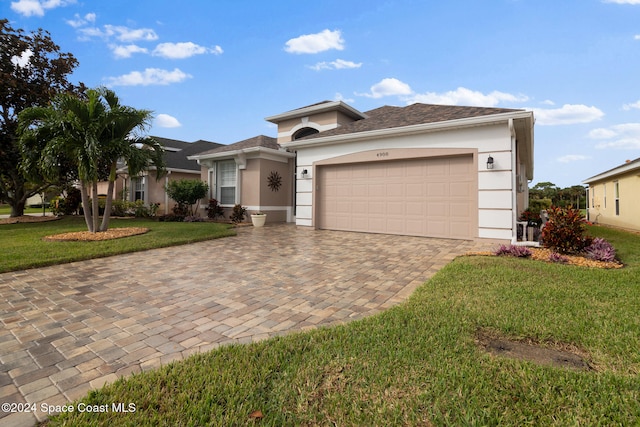 view of front of property featuring a garage and a front lawn