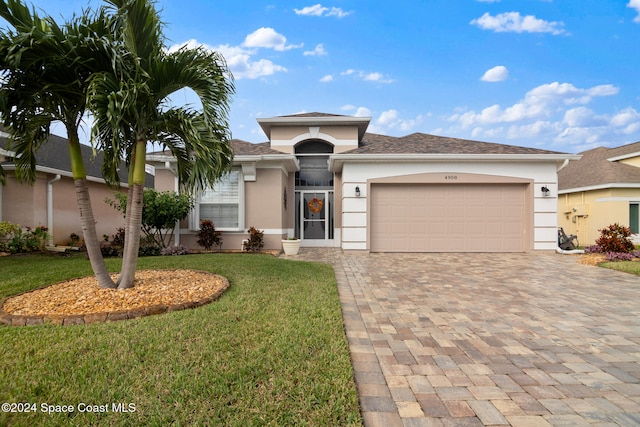 view of front of home with a garage and a front yard