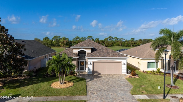 view of front of house with a front yard and a garage