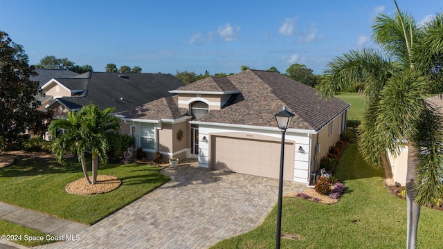 view of front of house with a garage and a front yard