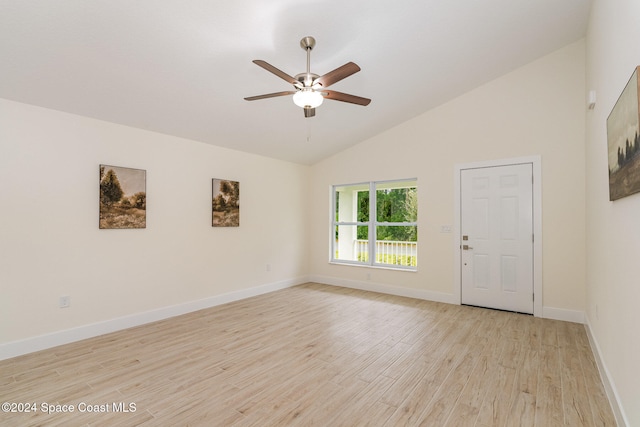 spare room with light hardwood / wood-style floors, high vaulted ceiling, and ceiling fan