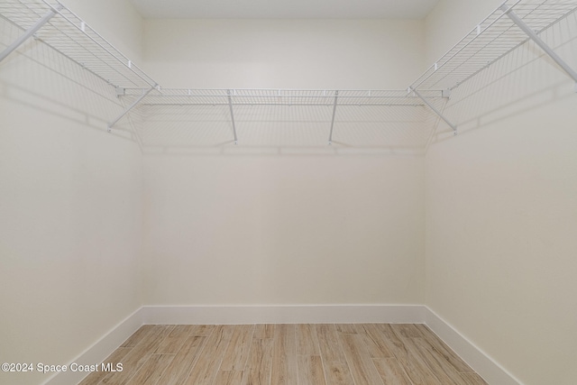 walk in closet featuring hardwood / wood-style floors